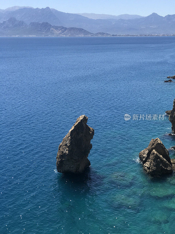 Kumluca Fener Halk Plajı, Muratpasa, Antalya, Turkey. Sea landscape with rocks at the day. Sunny, good weather. Mountain and Turkish city photography, traveling photo for tourism. Beach and water.